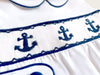 Little Collins Clothing white babygrow with smocking, peter pan collar and blue anchors detailed close up