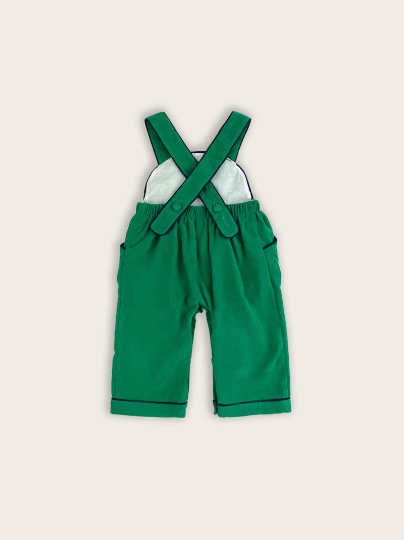 Green corduroy children's overalls rear view showing the back button straps and internal lining.