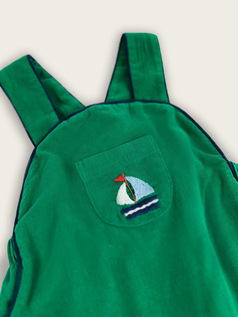 Close up of pocket with a blue sailboat embroidered onto the front.