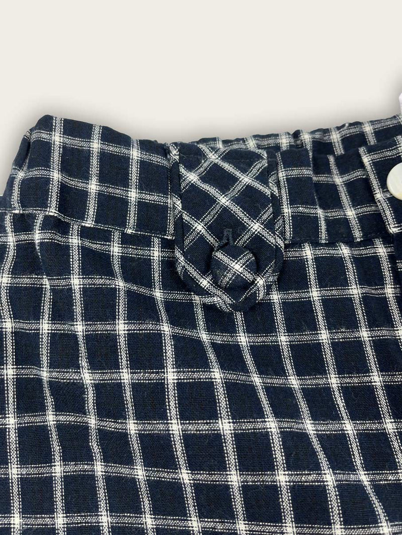 close up of french check shorts in blue with front button details.