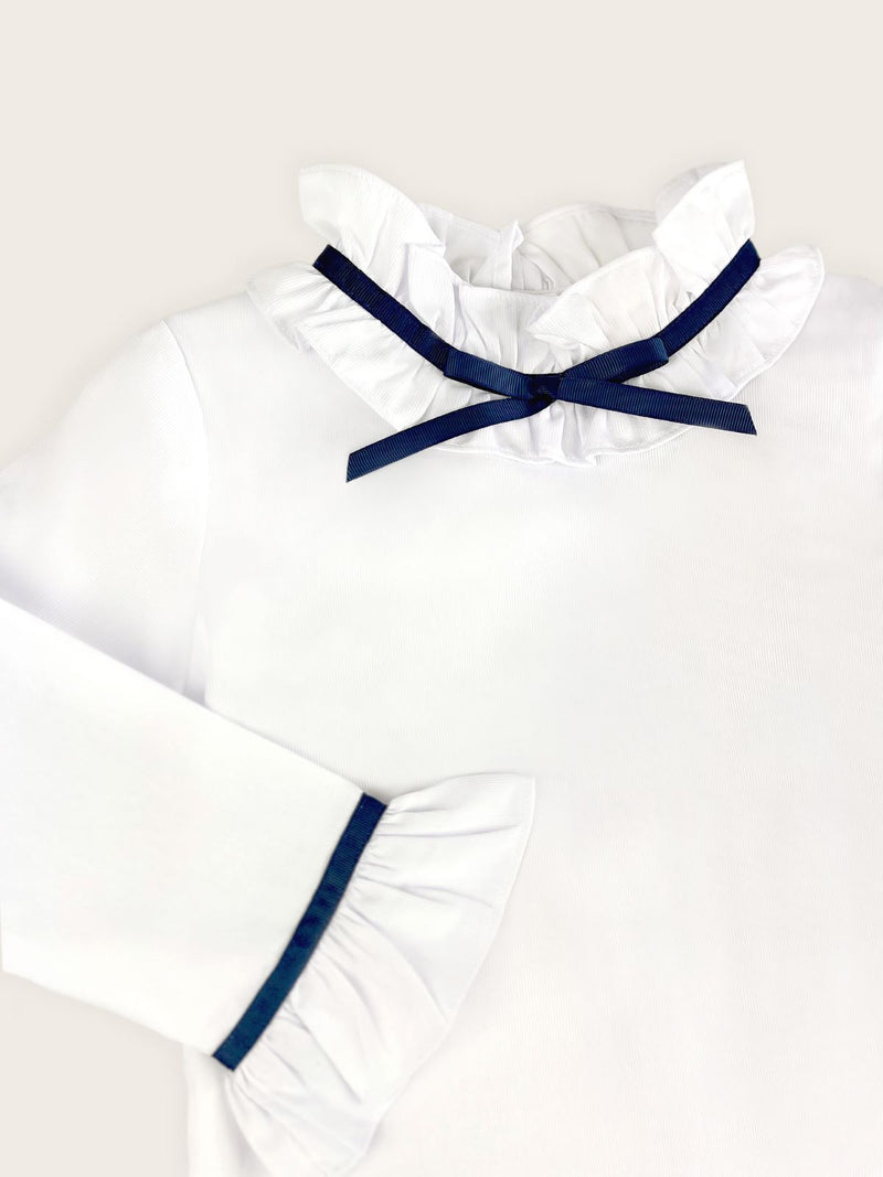 close up of blue grosgrain ribbon collar on girls white blouse