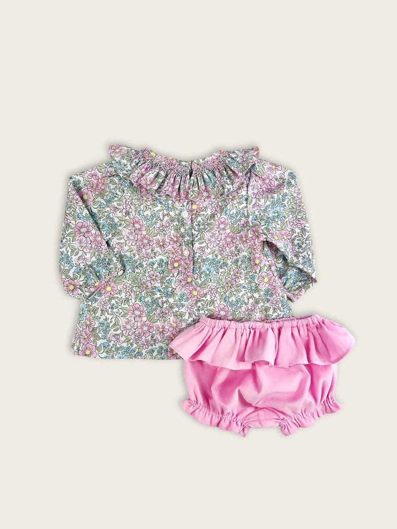 Rear view of the floral baby and toddlers blouse with frilled pink corduroy bloomers, featuring a frilled collar with hand smocking.